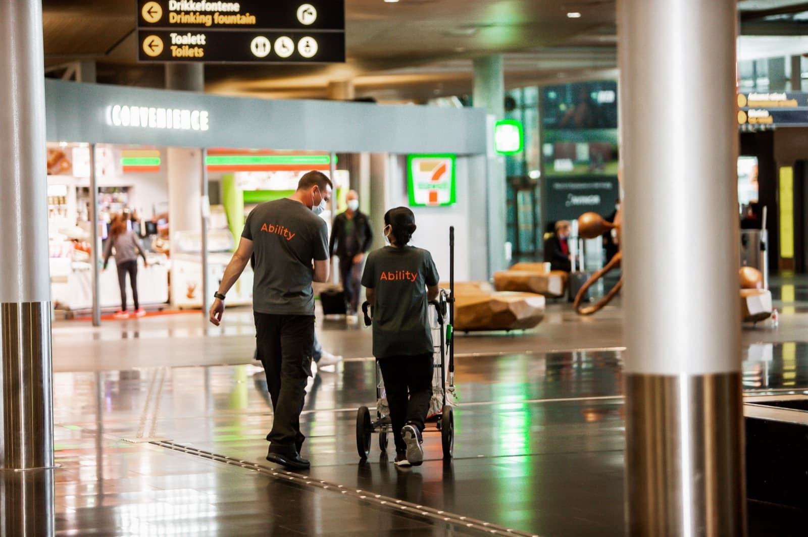 Two Ability cleaners at work in an airport terminal