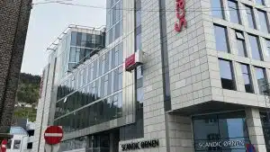 En medarbeider er oppi en lift og utfører fasadevask på Scandic Ørnen i Bergen